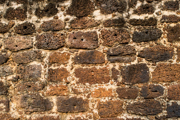  The Laterite brick walls texture of an ancient Buddhist temple in the Ayutthaya Historical Park, Ayutthaya province, Thailand. 