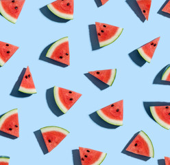 Sliced watermelons arranged on a blue background