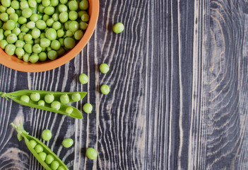 peas on a dark wooden background