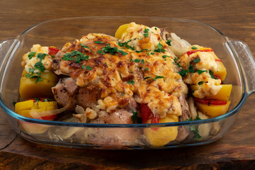 Chicken with potatoes, onions and tomatoes, baked in the oven with a ruddy crust of grated hard cheese.