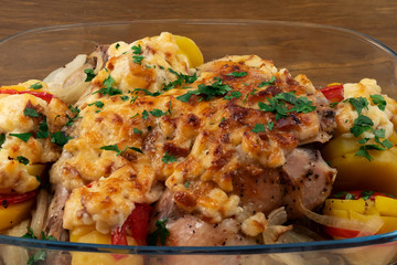 Baked under cheese crust chicken with vegetables, sprinkled with chopped parsley and Basil.