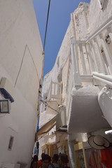 Beautiful Balconies In The Picturesque Streets Very Narrow Full Of Shops In Chora Island Of Mikonos .Arte History Architecture July 3, 2018. Chora, Mykonos Island, Greece.