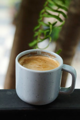Well mixed black hot black coffee in white coffee cup on wood table served in a restaurant in a coffee break time, popular drink for meeting place and party time, value added design for better sales