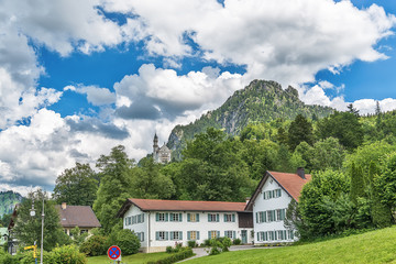 Naklejka premium Schwangau, Germany June 10, 2018: Famous Neuschwanstein Castle with scenic mountain landscape near