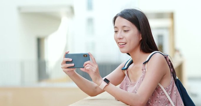 Woman taking photo on cellphone in Shum Yip Upperhills of shenzhen