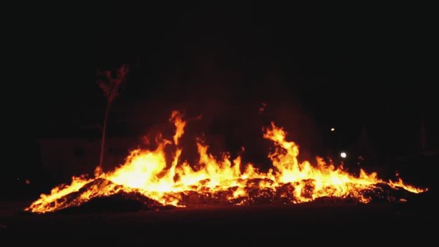 Burning of paper-made statues and joss paper during Hungry Ghost Festival.