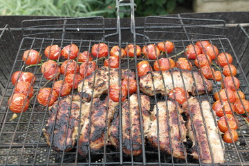pork with cherry tomatoes on grill