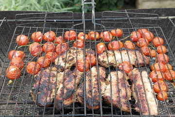 pork with cherry tomatoes on grill