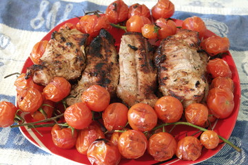 pork with cherry tomatoes on grill