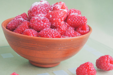 Raspberries in a ceramic bowl. Candid.