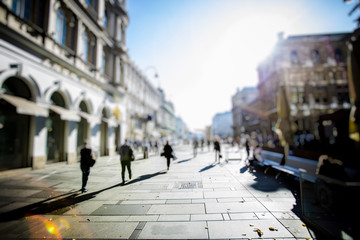 Crowd of anonymous people walking on busy city street