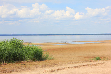 Baltic Sea Shore with Empty Sandy Beach in St. Petersburg, Russia. Summer Nature Landscape with Empty Beach and Calm Water Surface with No People on Bright Sunny Day. 