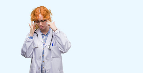 Young redhead woman wearing doctor uniform with hand on head for pain in head because stress. Suffering migraine.