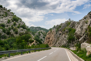 Concept picture of road trip in Montenegro, beautiful road pass through the greenery & stone mountain