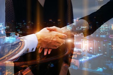 double exposure of midsection young man handshake with business woman after finishing up meeting with modern city background, partnership, teamwork, connection financial and investment concept