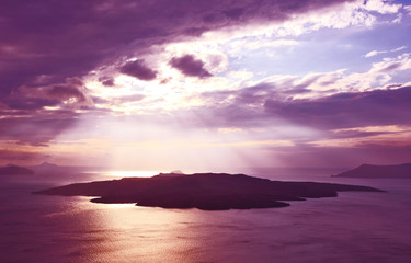 Sihouette Volcano in Thira Santorini Greece with light overlay and purple filter.