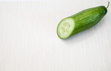 Isolated cucumbers. One whole cucumber and slices of cucumber isolated on white background