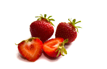 Strawberry with sliced half and leaves isolated on white background with clipping path. Strawberry whole and cut into halves. Close-up. Red strawberries.