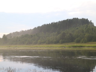 Fishing on the river in the summer evening