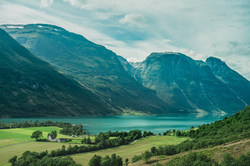 Fototapeta premium Green fjord in Norway with mountain and grass