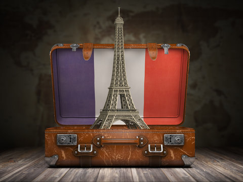 Trip to Paris. Travel or tourism to France concept. Eiffel tower andvintage suitcase with flag of France on the map of world background