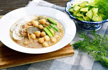 Rice noodles in pickled fish with herb and curry soup with small fish balls Serve with many vegetables. ( Thai name is Kanom Jeen Nam Ya Pa )