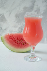 Watermelon juice and a piece of watermelon