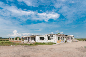 Abandoned office building with beautiful blue sky , anti government slogans on the walls.