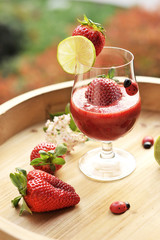 a cocktail with strawberries and lime. Summer drinks. Copy space.