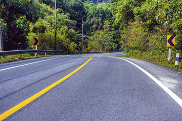Fototapeta premium Country road in the mountains with forest