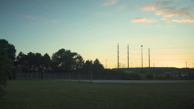 Empty baseball diamond at dusk in park