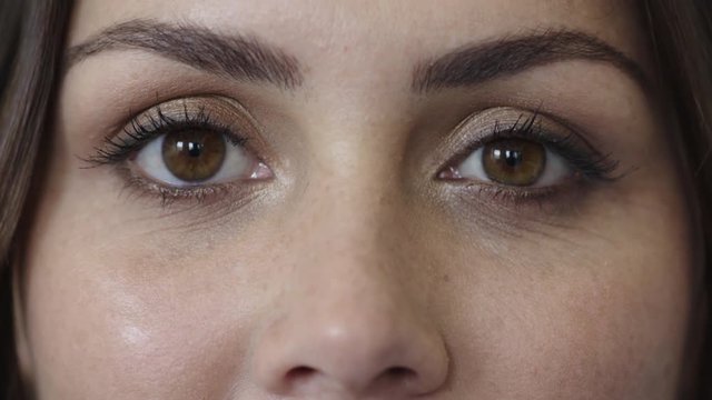 close up of beautiful woman eyes looking happy expression wearing makeup cosmetics female beauty concept