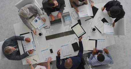 professional business people meeting in boardroom multi ethnic corporate leaders collaborating sharing ideas planning strategy using tablet pc overhead