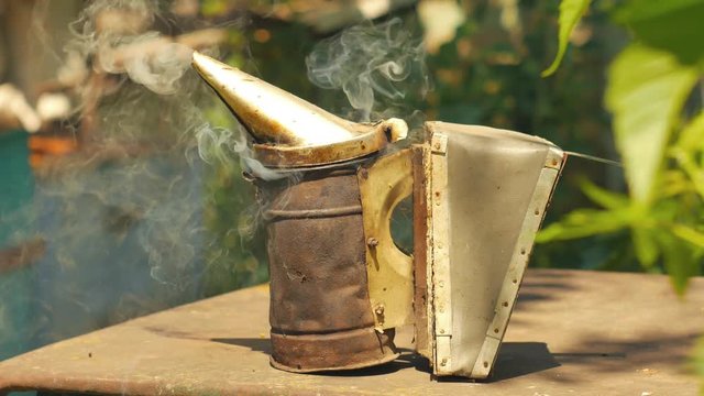 Bee maker of a smoke pipe beeper smoker device for repelling evil bees.