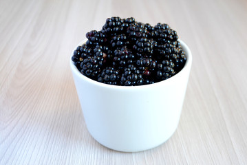Blackberry in the cup. Summer berry