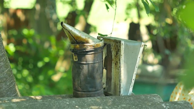 Bee maker of a smoke pipe beeper smoker device for repelling evil bees.