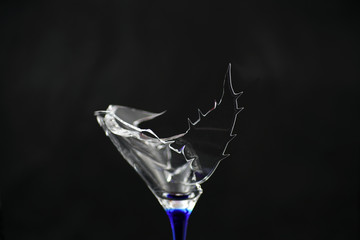 Broken glass in front of black background photographed under the name glass shards cocktail
