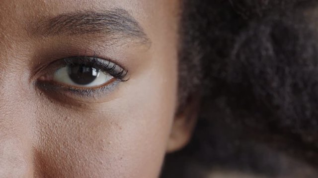 close up of african american woman eye looking at camera pensive contemplative beautiful detail 