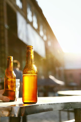 Bottles With Beer On Table Outdoors Closeup