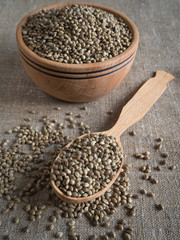 Ecological hemp seeds in a wooden bowl.