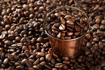 Vintage copper bucket on coffee beans background