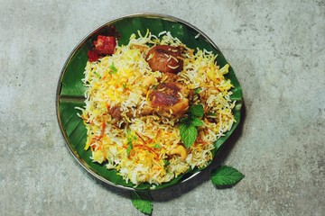 Homemade Chicken Biryani on banana leaf overhead view