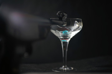 Broken glass in front of black background photographed under the name glass shards cocktail
