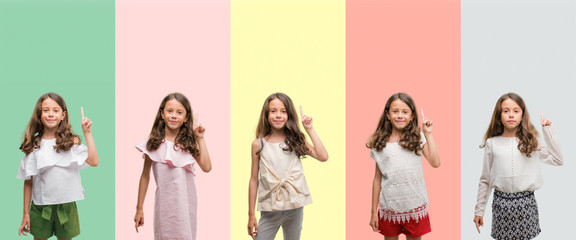 Collage of brunette hispanic girl wearing different outfits showing and pointing up with finger number one while smiling confident and happy. © Krakenimages.com