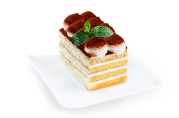 Tiramisu cake on a white plate isolated