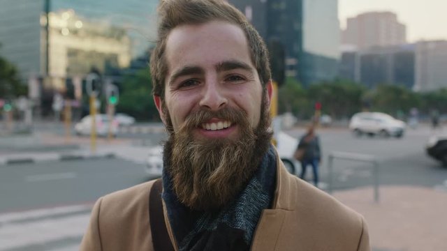 close up portrait of happy young bearded hipster man smiling cheerful enjoying city urban lifestyle commuting