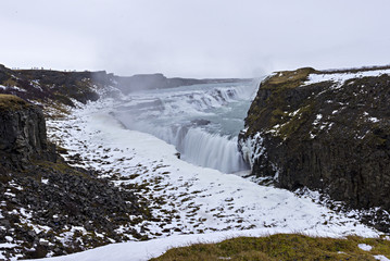 Gullfoss waterfall from Reykjavik in Iceland. A half frozen triangle as the Hvita River falls into a wintry gorge in Western Iceland