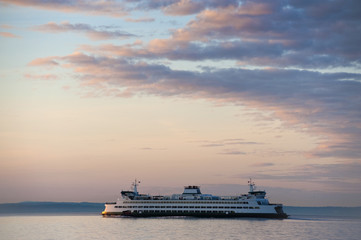 Fototapeta na wymiar Ferry Boat Crossing Elliott Bay from Seattle to Bainbridge Island. During a lovely Pacific Northwest sunset a Washington State ferry makes the sailing from Coleman Dock/Seattle to Bainbridge Island. 