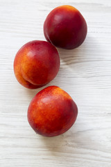 Nectarines on a white wooden table, top view. Closeup.