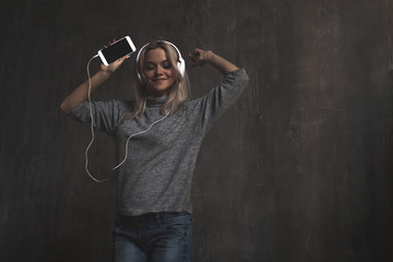 Young and attractive woman listening to music in the mobile app